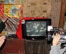 Ayue Shibo, a village farmer from Yuexi County, Sichuan Province show us his new TV donated by WWF. It's powered by a micro hydro-power system that has been set up in the village.